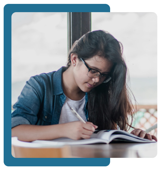 young woman writing in a book