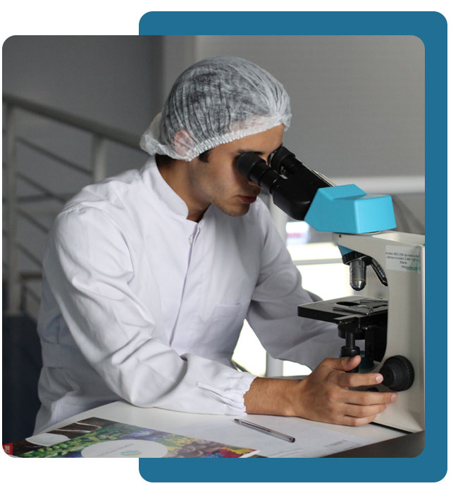 man using a microscope